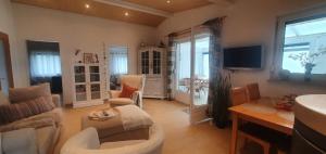 a living room with a couch and a table at Ferienhaus Frische Brise direkt am Nordsee Deich in Spieka-Neufeld