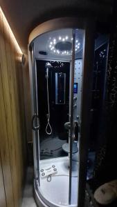 a small bathroom with a shower in a room at Zakątek u Poety Dąbrówka in Jasło