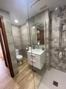 a bathroom with a toilet and a sink and a shower at Ático Playa Sardina in Gáldar