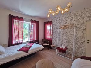a bedroom with a bed and a brick wall at Villa Vin Santo 
