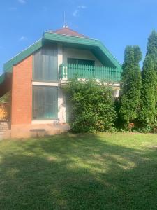 a house with a lawn in front of it at Veritas Apartment Zamárdi in Zamárdi