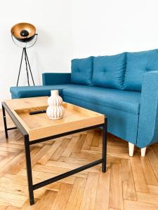 un sofá azul y una mesa de centro en la sala de estar. en Jen tak spolu - apartmán Znojmo en Znojmo