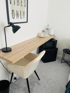 a desk with a white chair and a lamp at Simple Stay-Double Room Escape with Modern Luxury in Portchester