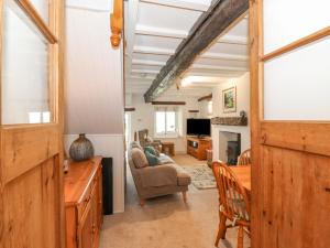 a living room with a couch and a table at Squirrel Cottage in Keswick