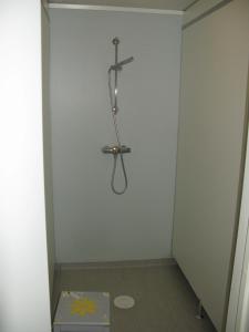 a room with a shower in a wall with a box at Hardanger Hostel B&B in Lofthus