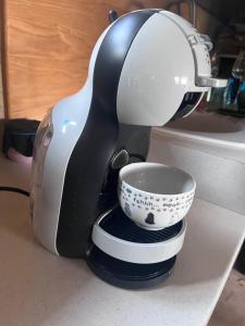 a coffee maker sitting on a counter with a cup at Apartmány pod Kozákem in Velké Popovice