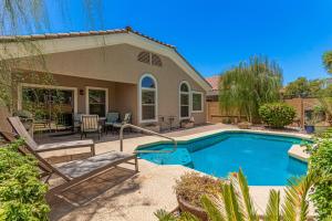 a swimming pool in front of a house at Serenity Haven with Private Pool in Gilbert in Queen Creek