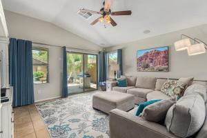 a living room with a couch and a ceiling fan at Serenity Haven with Private Pool in Gilbert in Queen Creek