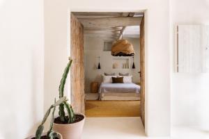 a bedroom with a bed and a potted plant at Agroturismo Can Domo in Santa Eularia des Riu