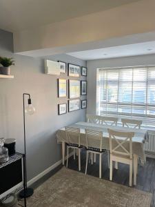 a dining room with a table and chairs at 4 bed Family home in Bicester in Bicester