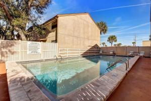 a swimming pool in front of a building at Across the Street from Beach Access-Pool & Garage-Sleeps 6-Sea Castle 12 in Fernandina Beach