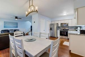 a kitchen and living room with a table and chairs at Across the Street from Beach Access-Pool & Garage-Sleeps 6-Sea Castle 12 in Fernandina Beach