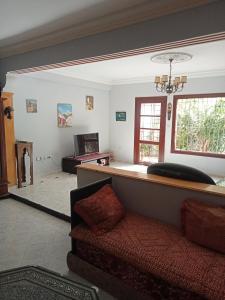 a living room with a couch and a table at Villa sidi Bouzid in El Jadida