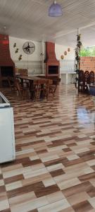 a room with wooden tables and chairs and a piano at Hospedaje Emma in Ayolas