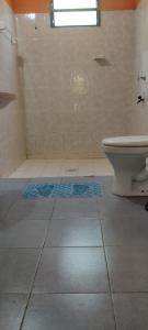 a bathroom with a shower and a toilet on the floor at Hospedaje Emma in Ayolas