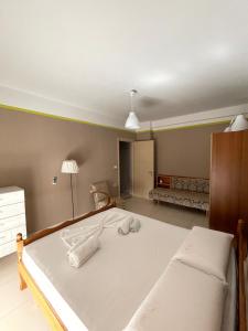 um quarto com uma cama grande e toalhas em Panoramic View Apartment em Përmet