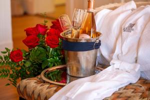 a bucket with a bottle of champagne and roses at Kehoe House, Historic Inns of Savannah Collection in Savannah