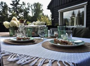 a table with plates of food and glasses on it at Oto Widoki in Szklarska Poręba