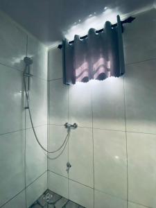 a bathroom with a shower with a shower curtain at SICE- Apartment 1 in Meerzorg
