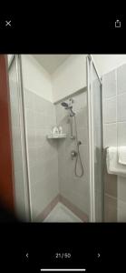 a shower with a glass door in a bathroom at NaCity Holiday Home in Naples