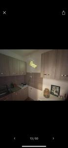 a kitchen with wooden cabinets and a cake on a counter at NaCity Holiday Home in Naples