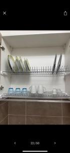 a shelf with plates and utensils in a kitchen at NaCity Holiday Home in Naples