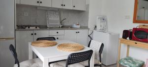 a kitchen with a white table with two hats on it at DALIUS HOME - Apartment with pool near the dunes of Maspalomas in Playa del Ingles