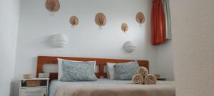 a bedroom with a bed with two pairs of shoes on it at DALIUS HOME - Apartment with pool near the dunes of Maspalomas in Playa del Ingles