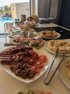 a buffet with plates of food on a table at Sea Holly Gozo in Nadur
