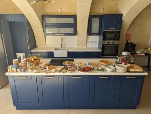 a kitchen counter with many plates of food on it at Sea Holly Gozo in Nadur