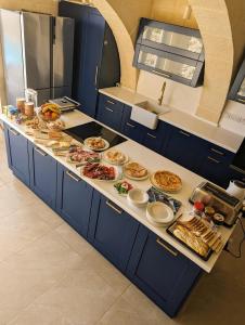 a kitchen counter with many plates of food on it at Sea Holly Gozo in Nadur