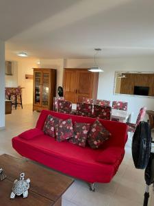 a red couch in the middle of a living room at Paribahia in Praia do Forte +84 photos