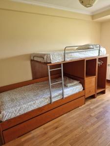 two bunk beds in a room with wooden floors at Portugal Beach Point in Vila Nova de Gaia