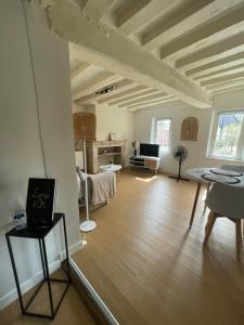 a living room with a wooden floor and white ceilings at Charmant Duplex - Au bord de l'Eure in Chartres