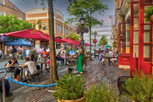 a rendering of a street with people sitting at tables at The Payne House Old Town, Metro, Free Parking in Alexandria