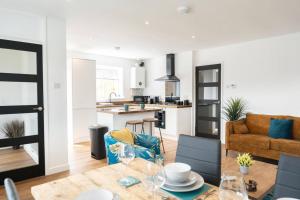 a kitchen and a living room with a table and chairs at Bungalow in Keynsham in Keynsham