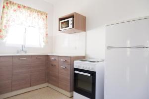 a kitchen with a white stove top oven next to a window at Shamrock Apartments in St. Paul's Bay