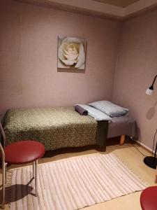 a bedroom with a bed and a flower on the wall at Aalto 17 in Haapsalu