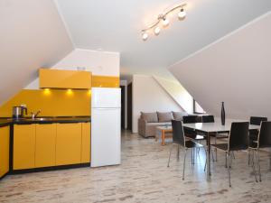 a kitchen and dining room with a table and chairs at Seaside Cottage in Cisowo with terrace and lovely garden in Darłowo