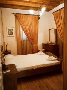 a bedroom with a large bed and a mirror at Kladas House Xanthates Corfu in Xanthátai