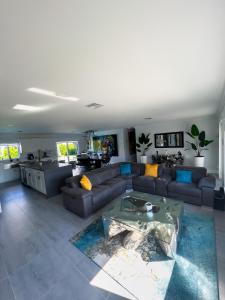 a living room with a couch and a table at House Of Art - Luxury Villa with Pool & Jacuzzi! in Tamiami