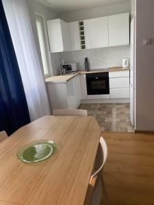 a kitchen with a wooden table with a plate on it at Take a break apartment in Ustka