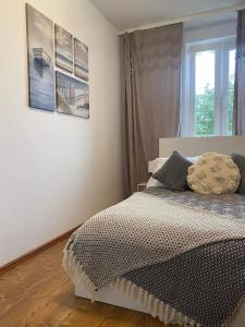 a bedroom with a bed and a window in it at Take a break apartment in Ustka