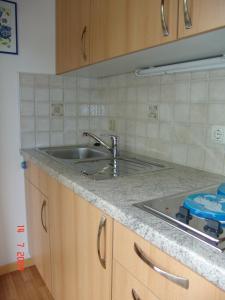 a kitchen with a sink and a stove at Pension Haus Christl in Kitzbühel