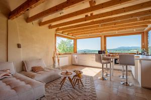 a living room with a couch and a table at Le Grand Nichoir de la Colline - Parking - Wifi in Mutzig +17 photos