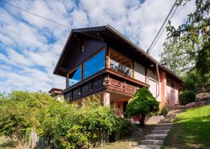 a house with a large window on the side of it at Le Grand Nichoir de la Colline - Parking - Wifi in Mutzig