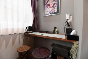 a room with a desk with a telephone and a stool at Hotel Tokyo Hub - Vacation STAY 27688v in Tokyo