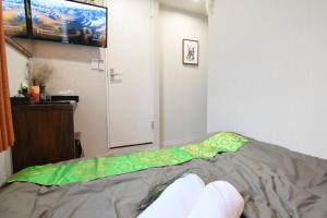 a person laying on a bed in a room at Hotel Tokyo Hub - Vacation STAY 27684v in Tokyo