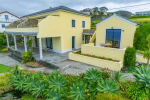 an aerial view of a yellow house at Casa dos Lagos - RRAL nº 2187 in Velas