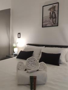 a bedroom with a white bed with a bike on the wall at Milan 3Suites in Milan